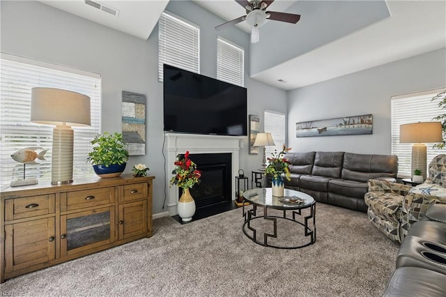 13435 Prince Andrew Trl, Carrollton, VA 23314 - living area with ceiling fan, light carpet, healthy amount of natural light, a fireplace with flush hearth, and a high ceiling