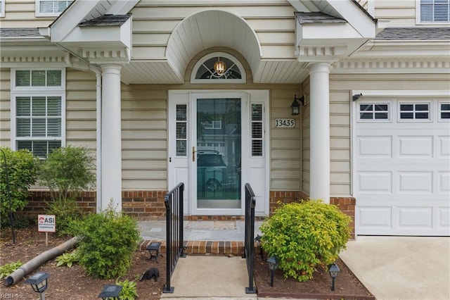 13435 Prince Andrew Trl, Carrollton, VA 23314 - property entrance with an attached garage and brick siding