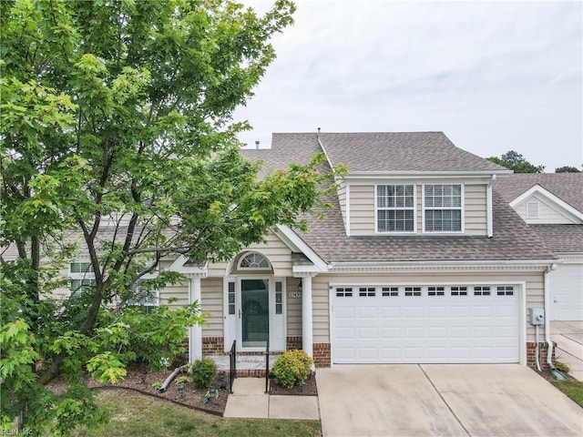13435 Prince Andrew Trl, Carrollton, VA 23314 - view of front of property with concrete driveway, roof with shingles, and brick siding