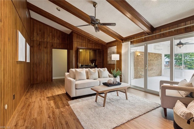 2438 Blue Castle Ct, Virginia Beach, VA 23454 - living room featuring a ceiling fan, wooden walls, wood finished floors, and a textured ceiling