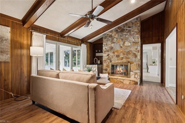 2438 Blue Castle Ct, Virginia Beach, VA 23454 - living room featuring wood finished floors, wood walls, a ceiling fan, a fireplace, and a textured ceiling