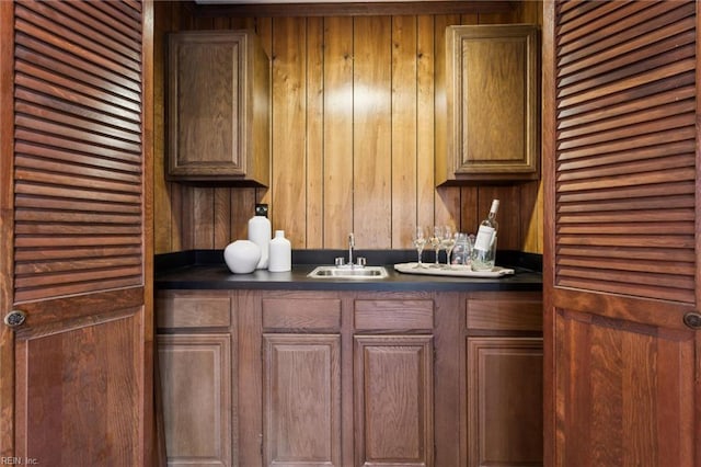2438 Blue Castle Ct, Virginia Beach, VA 23454 - kitchen featuring a sink, dark countertops, and wooden walls