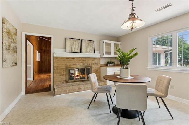 2438 Blue Castle Ct, Virginia Beach, VA 23454 - dining room with baseboards, a brick fireplace, and light carpet