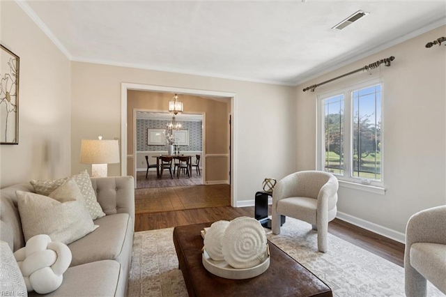 2438 Blue Castle Ct, Virginia Beach, VA 23454 - living room with wood finished floors, a chandelier, baseboards, and crown molding