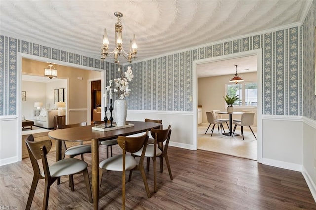 2438 Blue Castle Ct, Virginia Beach, VA 23454 - dining area with wallpapered walls, dark wood finished floors, a chandelier, ornamental molding, and baseboards