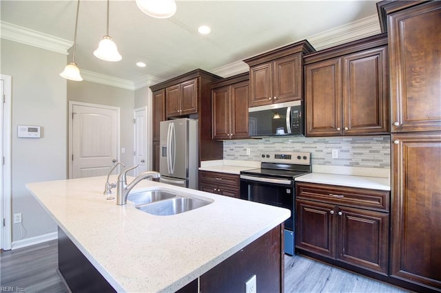 1808 Princeton Ave, Norfolk, VA 23523 - kitchen featuring appliances with stainless steel finishes, a sink, light wood-style flooring, an island with sink, and crown molding