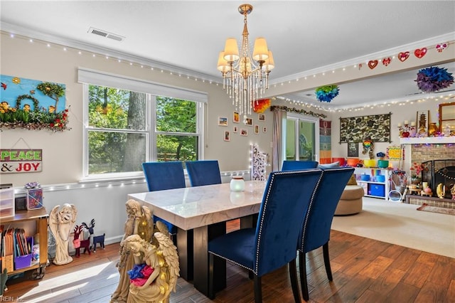 6372 Colby Way, Virginia Beach, VA 23464 - dining area featuring a chandelier, wood-type flooring, ornamental molding, and a brick fireplace