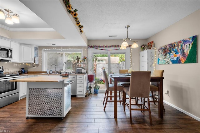 6372 Colby Way, Virginia Beach, VA 23464 - dining area featuring dark wood-type flooring, ornamental molding, a textured ceiling, and baseboards