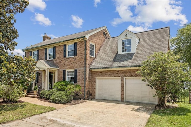 4002 Chesapeake Ave, Hampton, VA 23669 - view of front facade featuring concrete driveway, brick siding, a chimney, and a garage