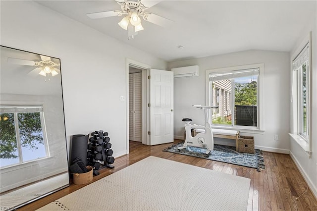 4002 Chesapeake Ave, Hampton, VA 23669 - living area featuring a wall mounted air conditioner, a ceiling fan, vaulted ceiling, wood finished floors, and baseboards