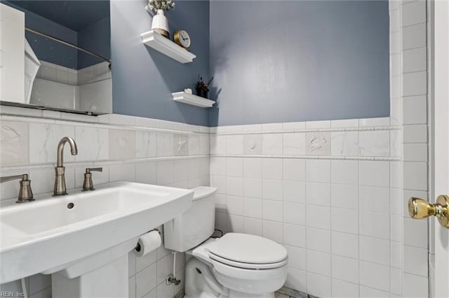 4002 Chesapeake Ave, Hampton, VA 23669 - bathroom with toilet, tile walls, a sink, a wainscoted wall, and a shower