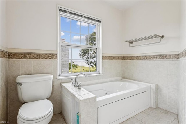 4002 Chesapeake Ave, Hampton, VA 23669 - full bathroom featuring tile walls, a jetted tub, wainscoting, toilet, and tile patterned floors