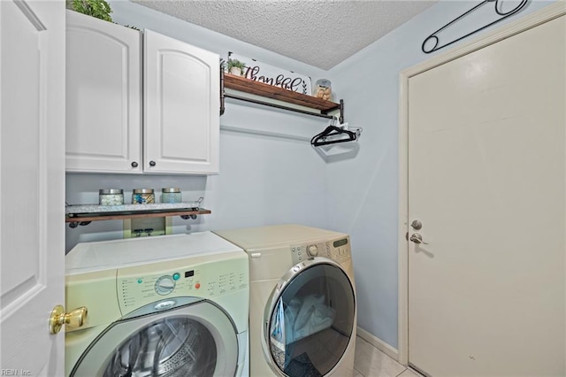 2753 Elson Green Ave, Virginia Beach, VA 23456 - laundry area featuring washing machine and dryer, cabinet space, a textured ceiling, and light tile patterned floors