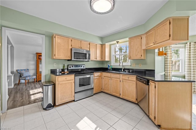 2753 Elson Green Ave, Virginia Beach, VA 23456 - kitchen with stainless steel appliances, a sink, dark countertops, and a peninsula