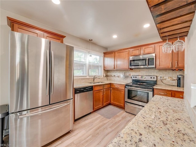 1803 Revere Dr, Hampton, VA 23664 - kitchen with stainless steel appliances, a sink, light wood-type flooring, light stone countertops, and backsplash