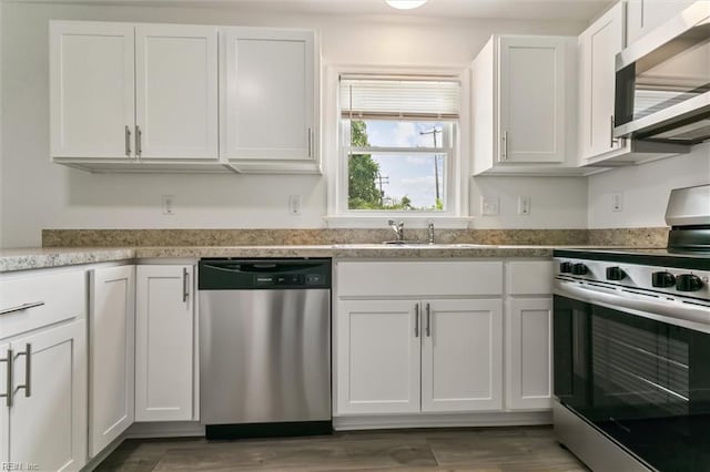 4 Greenwood Dr, Hampton, VA 23666 - kitchen with appliances with stainless steel finishes, white cabinets, light stone counters, and a sink