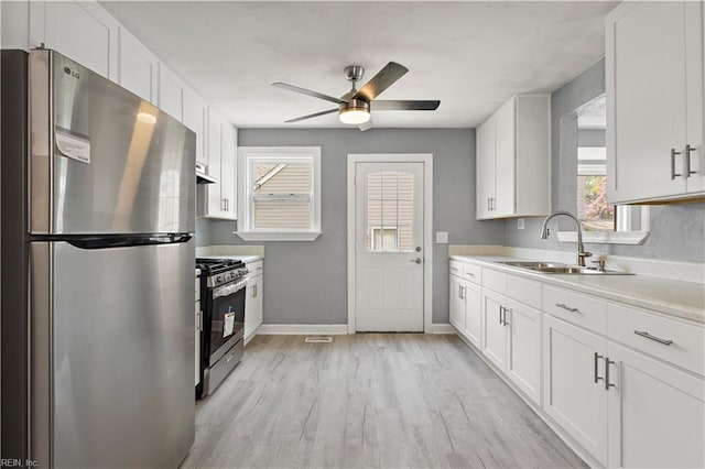 1020 Philpotts Rd, Norfolk, VA 23513 - kitchen with stainless steel appliances, a sink, ceiling fan, and white cabinetry
