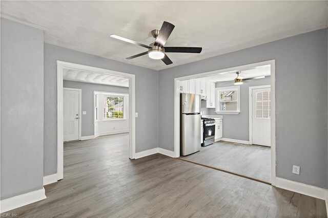 1020 Philpotts Rd, Norfolk, VA 23513 - unfurnished living room featuring a ceiling fan, wood finished floors, and baseboards