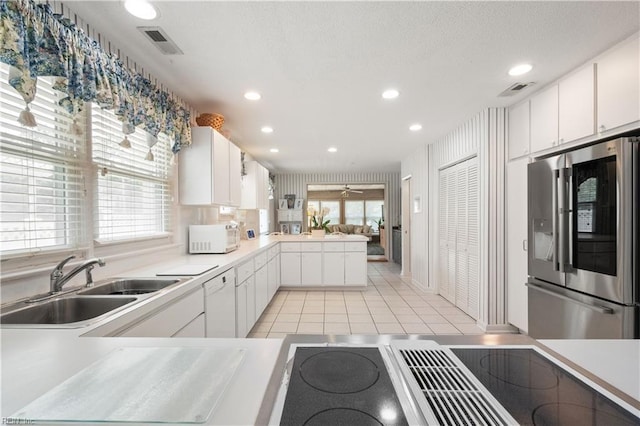 7006 Atlantic Ave, Virginia Beach, VA 23451 - kitchen featuring white appliances, a peninsula, a sink, light countertops, and recessed lighting