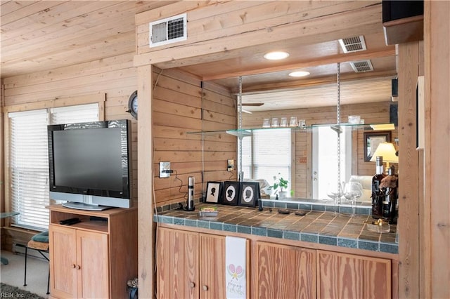 7006 Atlantic Ave, Virginia Beach, VA 23451 - kitchen featuring wooden walls, tile counters, healthy amount of natural light, light brown cabinets, and a baseboard heating unit