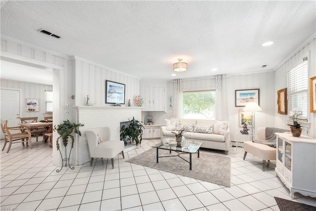 7006 Atlantic Ave, Virginia Beach, VA 23451 - living area with ornamental molding, light tile patterned floors, a textured ceiling, a baseboard heating unit, and recessed lighting