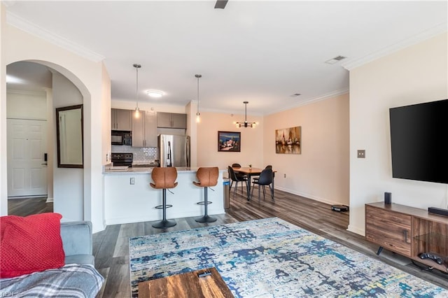 1400 Granby St Unit 413, Norfolk, VA 23510 - living area featuring dark wood finished floors, arched walkways, baseboards, ornamental molding, and a chandelier