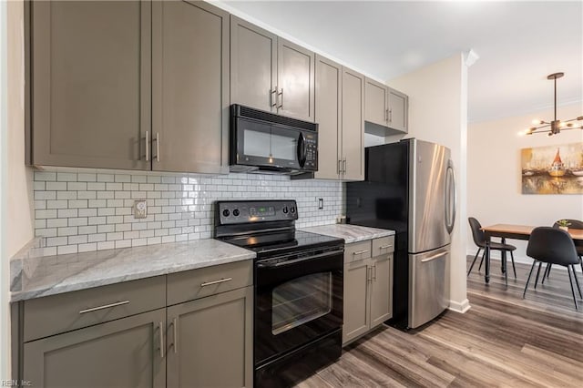 1400 Granby St Unit 413, Norfolk, VA 23510 - kitchen with black appliances, gray cabinets, light wood-type flooring, and decorative backsplash