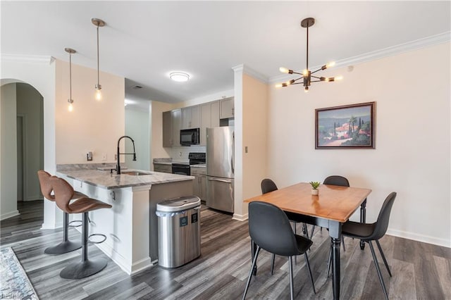 1400 Granby St Unit 413, Norfolk, VA 23510 - kitchen featuring black appliances, a sink, a peninsula, a kitchen breakfast bar, and dark wood-style flooring