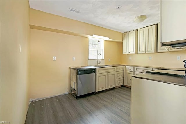 3124 Choctaw Dr, Virginia Beach, VA 23464 - kitchen featuring stainless steel dishwasher, a sink, cream cabinets, and wood finished floors