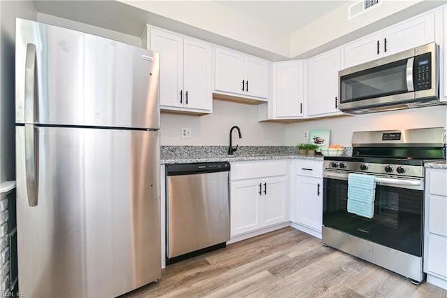 785 Biltmore Dr, Virginia Beach, VA 23454 - kitchen with appliances with stainless steel finishes, white cabinetry, light wood-style flooring, and light stone countertops