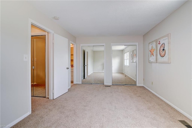 785 Biltmore Dr, Virginia Beach, VA 23454 - unfurnished bedroom featuring carpet, two closets, and baseboards