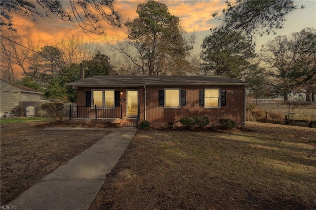 313 Delk St, Franklin, VA 23851 - view of front of property with brick siding, covered porch, and a front yard