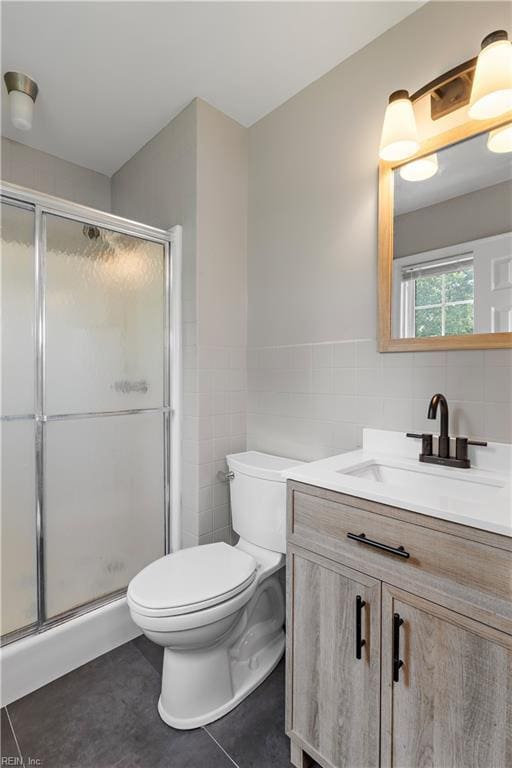 304 Odd Rd, Poquoson, VA 23662 - full bath featuring tile walls, toilet, vanity, a stall shower, and tile patterned flooring