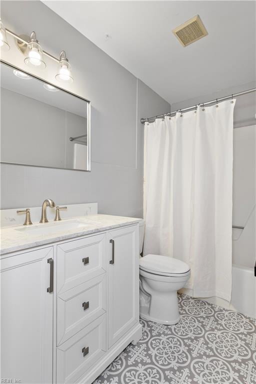 304 Odd Rd, Poquoson, VA 23662 - bathroom featuring toilet, vanity, tile patterned floors, and shower / bath combo