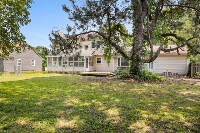 304 Odd Rd, Poquoson, VA 23662 - rear view of house with a sunroom, a chimney, and a wooden deck
