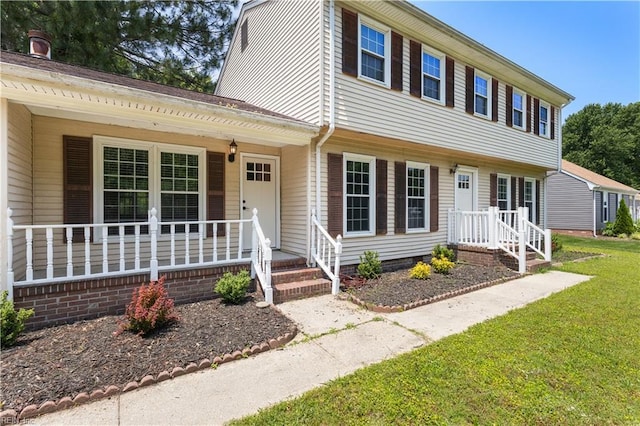 304 Odd Rd, Poquoson, VA 23662 - view of front of house featuring covered porch and a front lawn