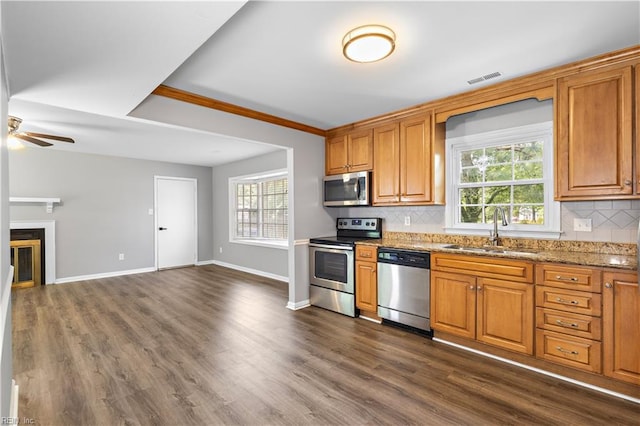 304 Odd Rd, Poquoson, VA 23662 - kitchen with appliances with stainless steel finishes, a sink, ceiling fan, backsplash, and healthy amount of natural light
