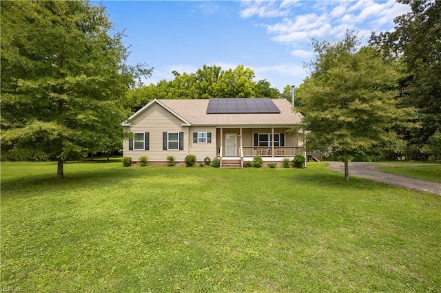 21187 Rescue Rd, Carrollton, VA 23314 - ranch-style house featuring covered porch, roof mounted solar panels, a front yard, and roof with shingles