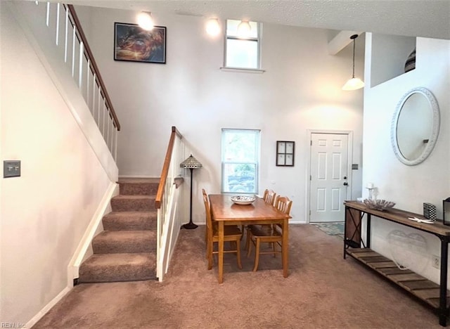 1417 Northface Ct, Virginia Beach, VA 23462 - dining space featuring light colored carpet, stairs, a towering ceiling, and baseboards