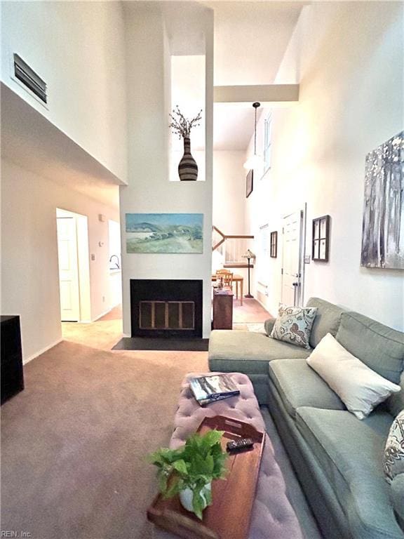 1417 Northface Ct, Virginia Beach, VA 23462 - carpeted living area with a high ceiling, a fireplace with flush hearth, and baseboards