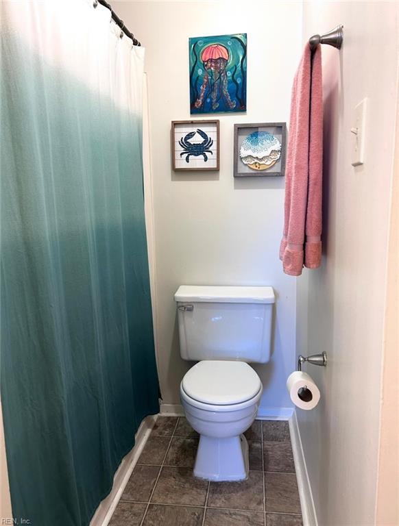 1417 Northface Ct, Virginia Beach, VA 23462 - bathroom with toilet, baseboards, tile patterned flooring, and curtained shower