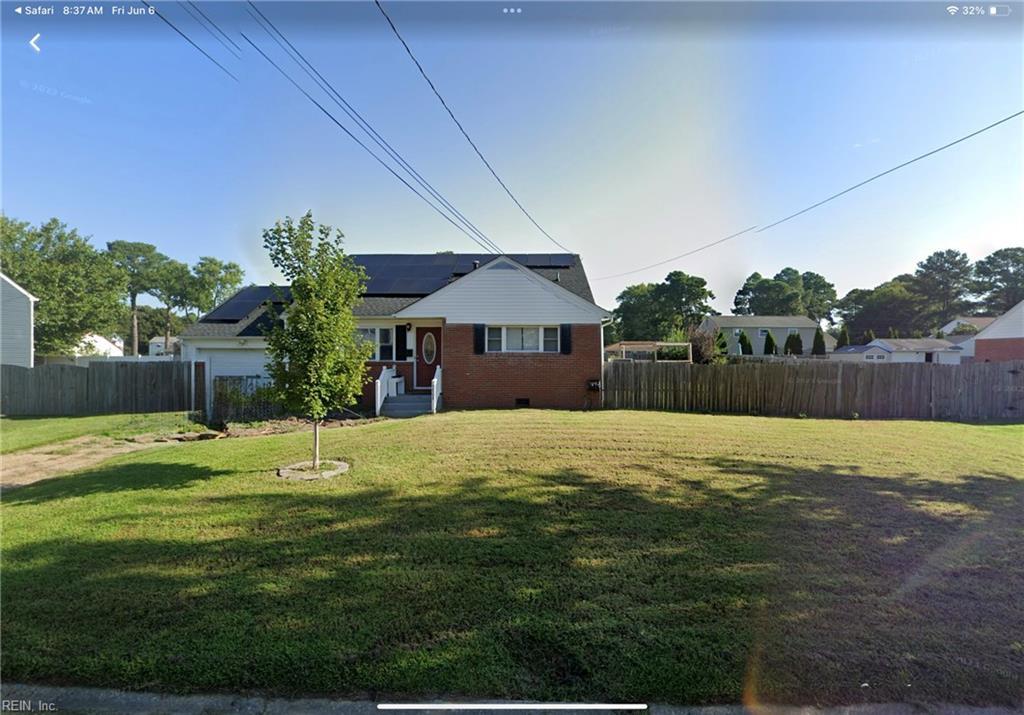 5808 S Ottawa Rd, Virginia Beach, VA 23462 - view of front facade featuring roof mounted solar panels, brick siding, and crawl space
