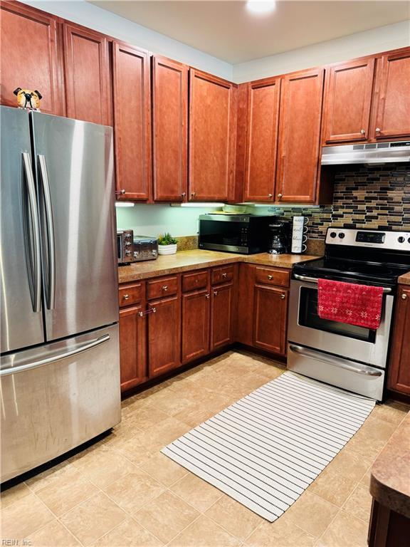5201 Nuthall Dr Unit 204, Virginia Beach, VA 23455 - kitchen with appliances with stainless steel finishes, under cabinet range hood, tasteful backsplash, and light countertops