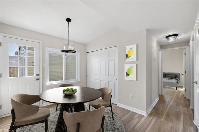 1857 Karen Ln, Virginia Beach, VA 23454 - dining area featuring light wood-style flooring, baseboards, a chandelier, and vaulted ceiling