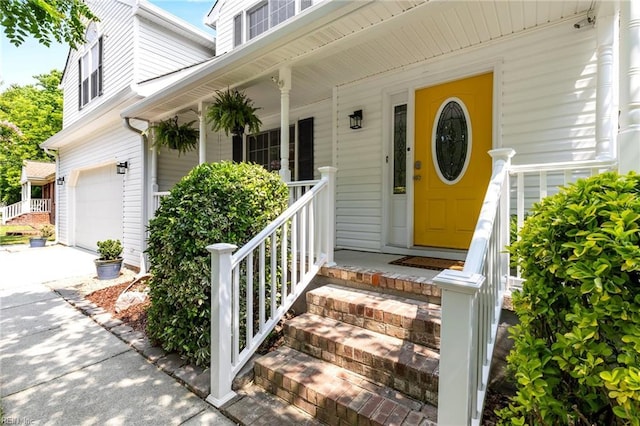1216 New Born Ct, Chesapeake, VA 23322 - view of exterior entry featuring an attached garage, covered porch, and driveway