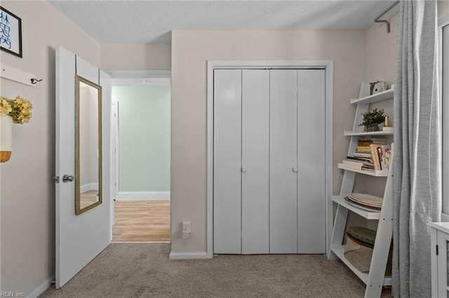 1216 New Born Ct, Chesapeake, VA 23322 - carpeted bedroom featuring a closet, baseboards, and a textured ceiling