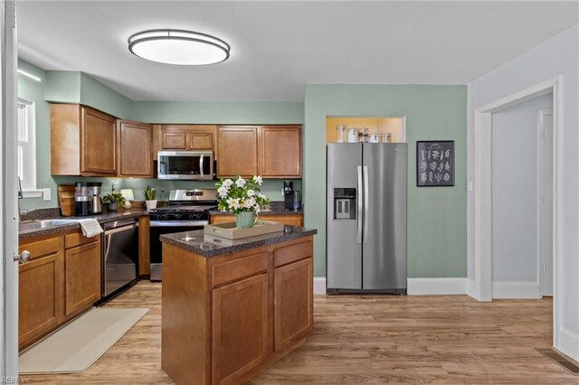 1216 New Born Ct, Chesapeake, VA 23322 - kitchen with stainless steel appliances, light wood finished floors, brown cabinets, a center island, and baseboards