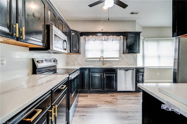 32 Gunter Ct, Hampton, VA 23666 - kitchen with appliances with stainless steel finishes, a sink, ceiling fan, dark cabinetry, and light wood-type flooring