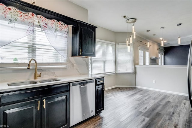 32 Gunter Ct, Hampton, VA 23666 - kitchen featuring dishwasher, a sink, dark cabinetry, light countertops, and wood finished floors