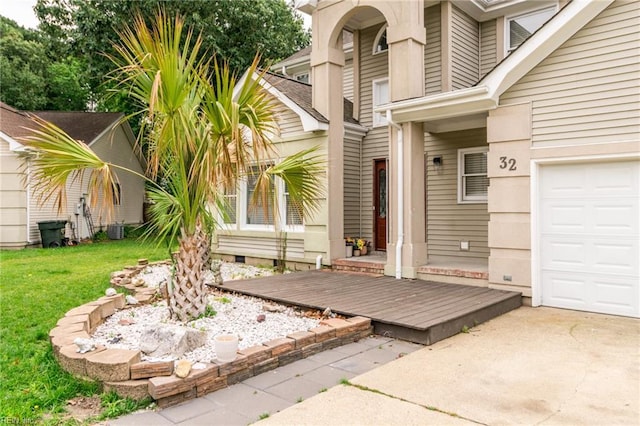 32 Gunter Ct, Hampton, VA 23666 - doorway to property featuring a lawn, an attached garage, and central AC unit